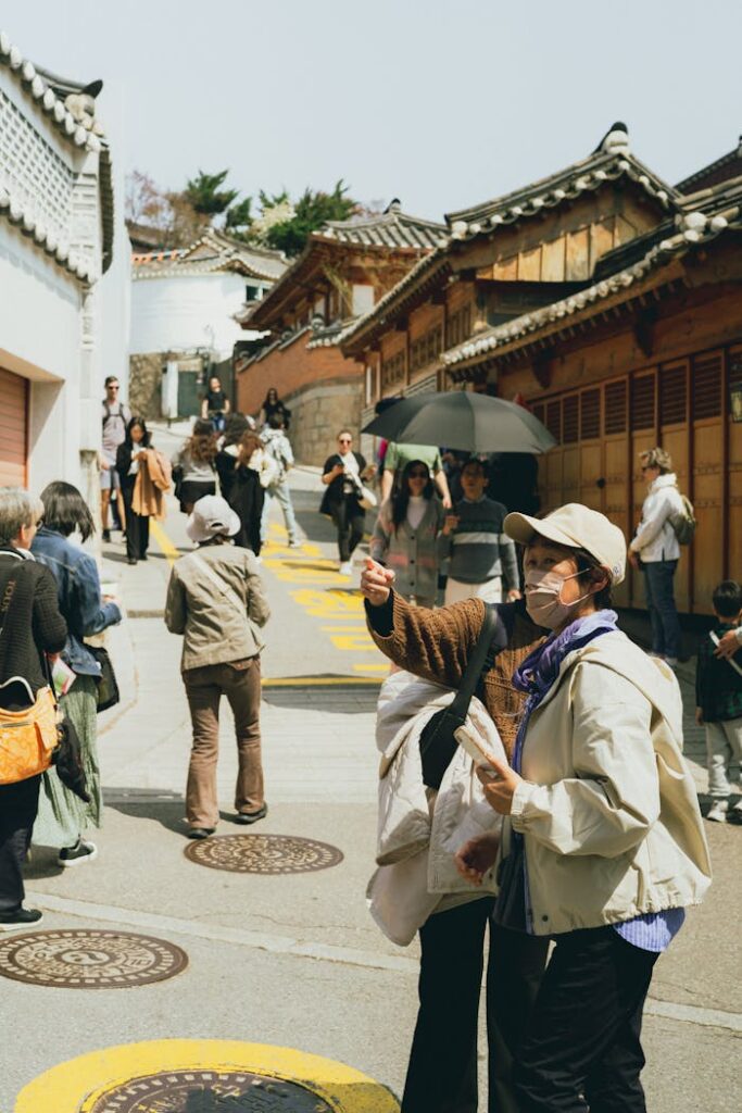 pexels-photo-32087626 Explore the lively street atmosphere in Seoul's traditional Bukchon Hanok Village, capturing local culture.